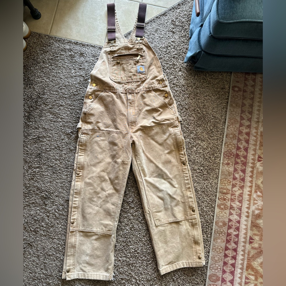 Vintage carhartt overalls with zip & snap side flaps.